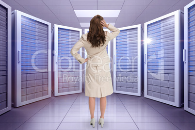 Composite image of businesswoman standing back to camera with ha