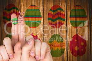 Composite image of fingers as easter bunny