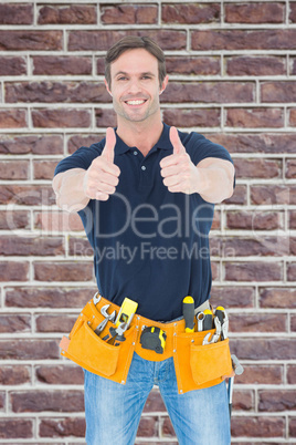 Composite image of man wearing tool belt while showing thumbs up
