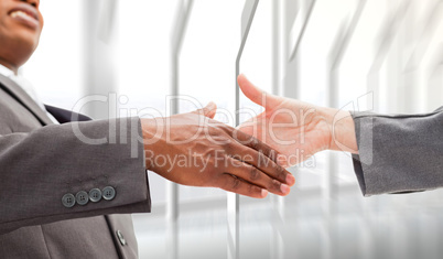 Composite image of businessman going shaking a hand
