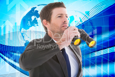 Composite image of focused handsome businessman holding binocula