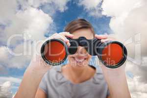 Composite image of woman looking through spyglasses