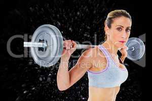 Composite image of strong female crossfitter lifting barbell beh