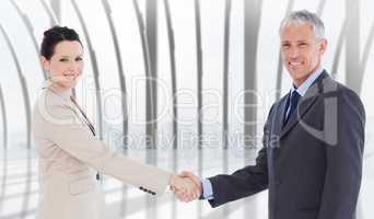 Composite image of smiling business people shaking hands while l