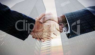 Composite image of business people shaking hands