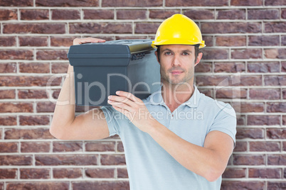 Composite image of confident worker carrying tool box on shoulde