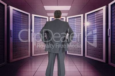 Composite image of businessman standing back to the camera with