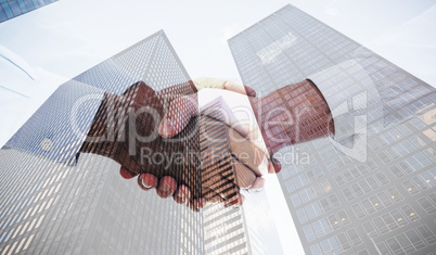 Composite image of close-up shot of a handshake in office