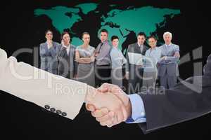 Composite image of smiling business people shaking hands while l