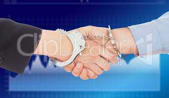 Composite image of business people in handcuffs shaking hands