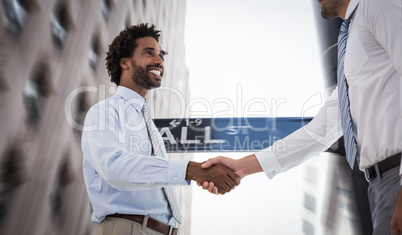 Composite image of two businessmen shaking hands in office