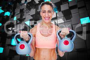 Composite image of smiling female crossfitter lifting kettlebell