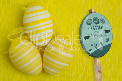 Composite image of easter egg hunt sign