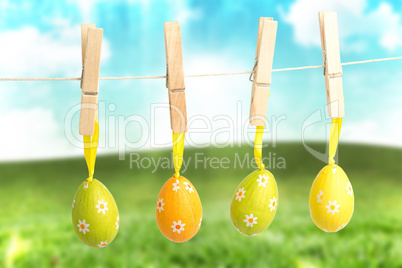 Composite image of hanging easter eggs