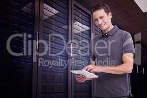 Composite image of smiling young man with tablet computer