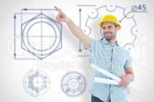 Composite image of male architect with blueprints pointing away
