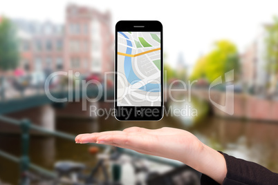 Composite image of hand showing map app on phone