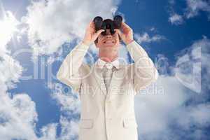 Composite image of confident businessman with binoculars