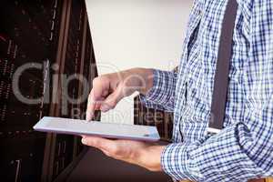 Composite image of geeky businessman using his tablet pc