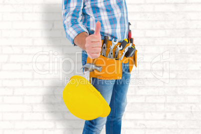 Composite image of midsection of manual worker gesturing thumbs