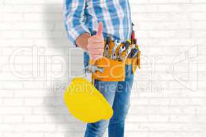 Composite image of midsection of manual worker gesturing thumbs