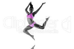 Composite image of fit brunette jumping and posing