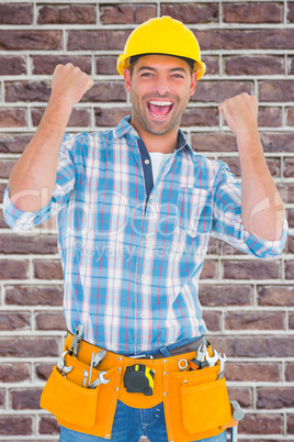 Composite image of excited manual worker clenching fists