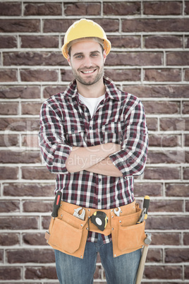 Composite image of confident male handyman wearing tool belt