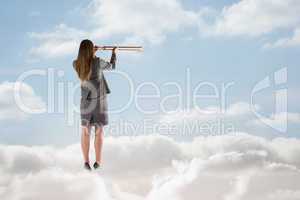 Composite image of businesswoman looking through a telescope