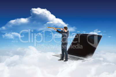 Composite image of businessman looking through telescope