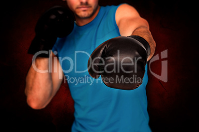 Composite image of close-up of a determined male boxer focused o