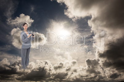 Composite image of curious young businesswoman posing with binoc