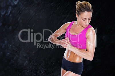 Composite image of female bodybuilder flexing with hands togethe