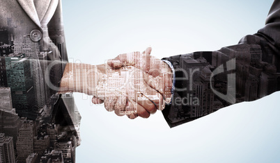 Composite image of close up of two businesspeople shaking their