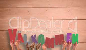 Composite image of hands holding up valkommen