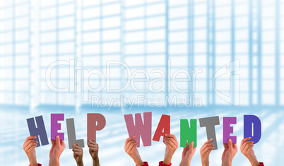 Composite image of hands holding up help wanted