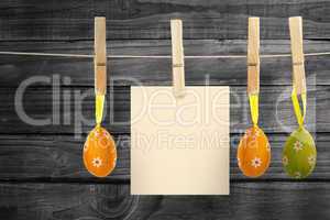 Composite image of hanging easter eggs and card