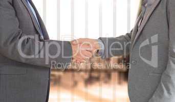 Composite image of close up on two businesspeople shaking hands