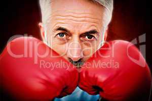 Composite image of close-up portrait of a determined senior boxe