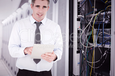 Composite image of portrait of a businessman with a tablet compu