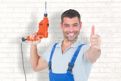 Composite image of smiling repairman with drill machine gesturin