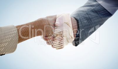 Composite image of closeup of shaking hands after business meeti