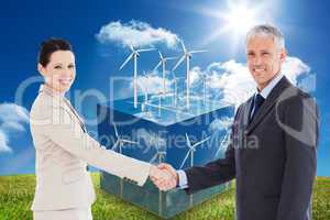 Composite image of smiling business people shaking hands while l