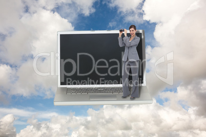 Composite image of businesswoman posing with binoculars