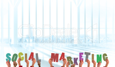 Composite image of hands holding up social marketing