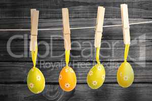 Composite image of hanging easter eggs