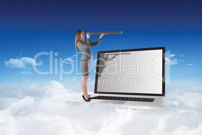 Composite image of businesswoman looking through a telescope