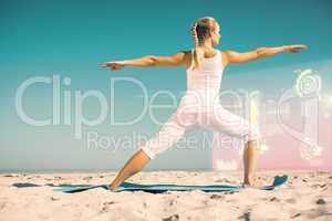 Composite image of calm woman standing in warrior pose on beach