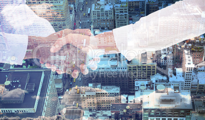 Composite image of close-up shot of a handshake in office