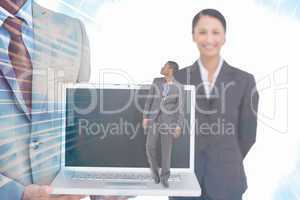 Composite image of businessman standing and looking